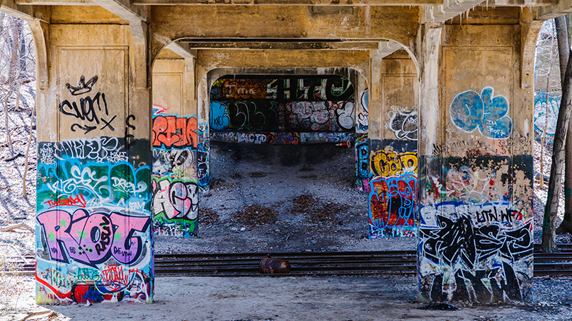 graffiti painted on the underside of bridge