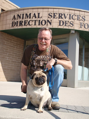 Photo of Shylee and owner Joseph H. in front of Animal Services