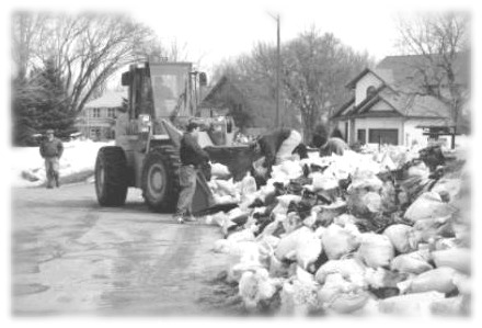 A picture of a front end loader moving sandbags, City of Winnipeg Photo