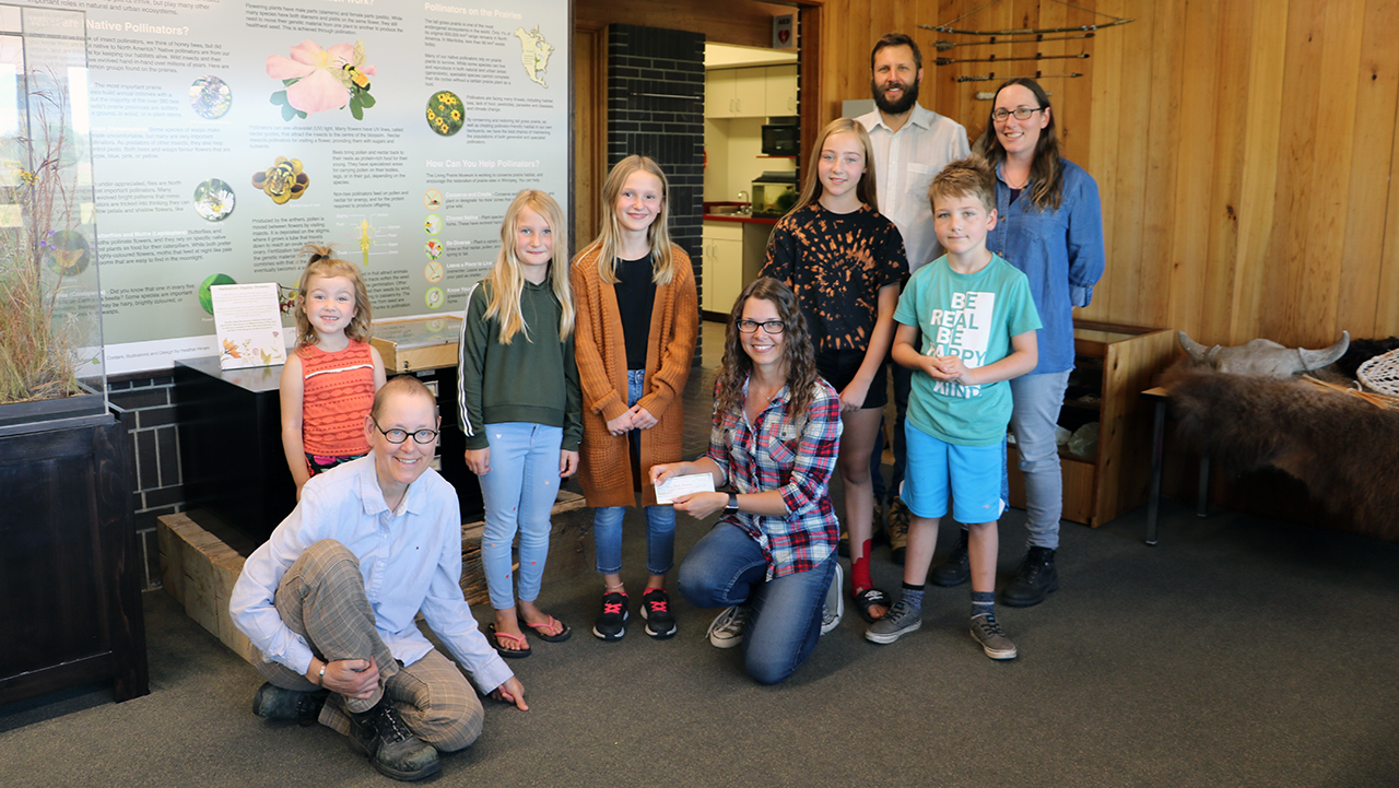 L-R Jewel Vitt, Violet Baschuk, Lily Baschuk, Jade Vitt, and Jase Vitt hand-delivered a cheque to the employees at Living Prairie Museum.