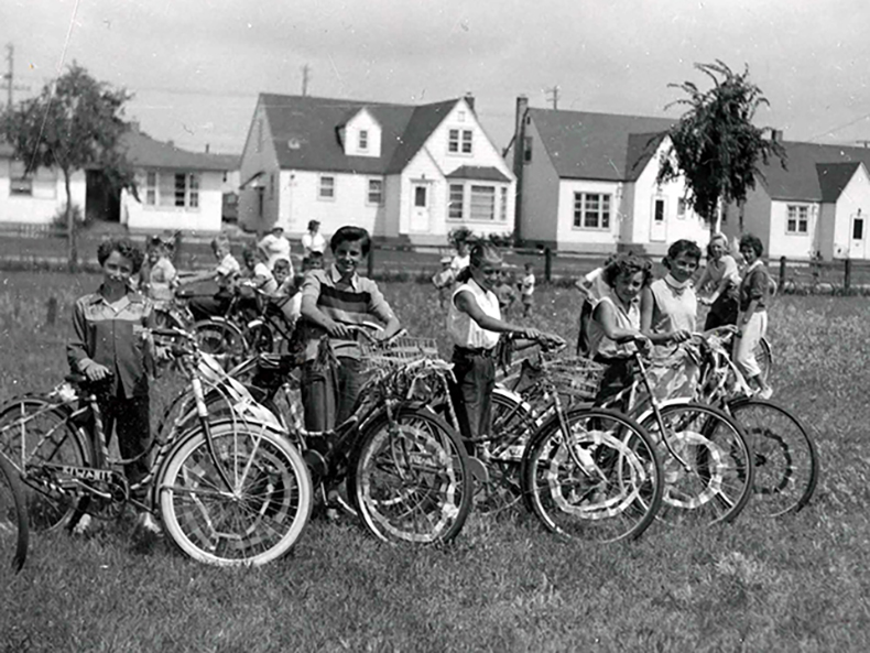 Group shot of kids posing with their bicycles, October 1955.