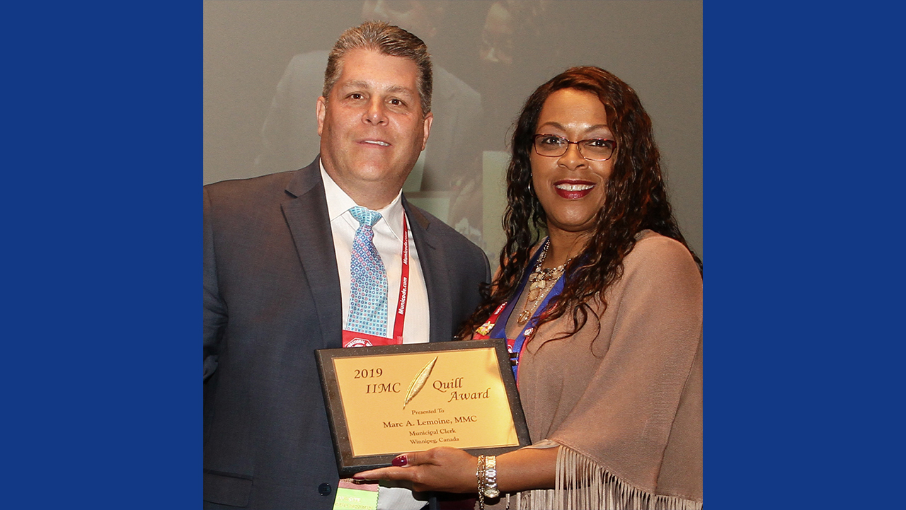  Marc Lemoine is presented the Quill Award by Stephanie Kelly, City Clerk of Charlotte, North Carolina.