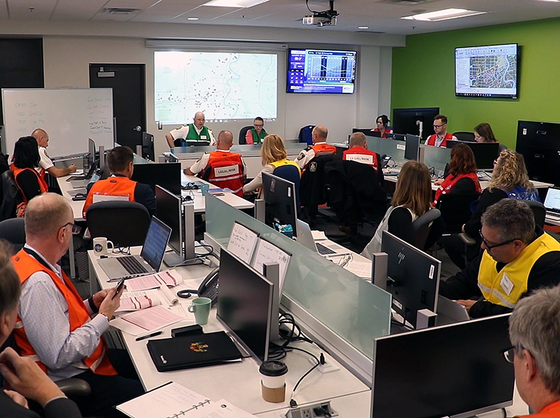 People sitting at desks in the Emergency Operations Centre (EOC)