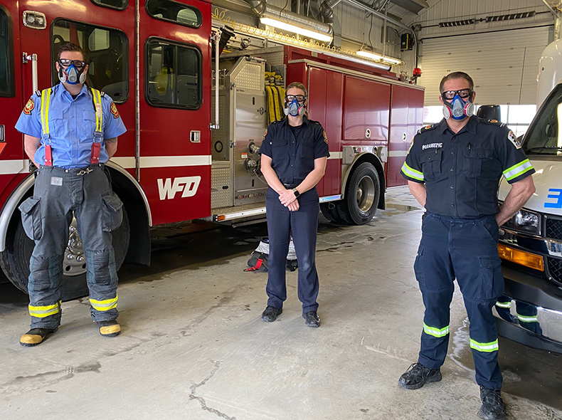 Fire and Paramedic staff wearing masks inside firehall