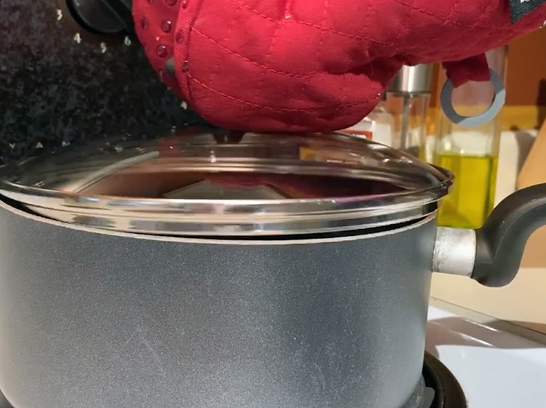 Pot on stove with a lid