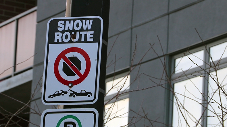 A sign displaying the street is a Designated Snow Route.