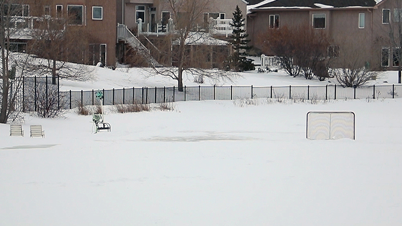 Hockey net and chairs on a frozen retention pond