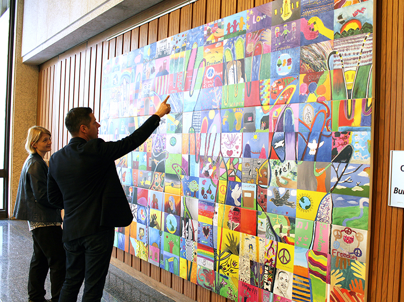 Mayor Brian Bowman is shown the 'Everybody has the Right' mural by Emma Prescott, HSC Winnipeg Archivist.