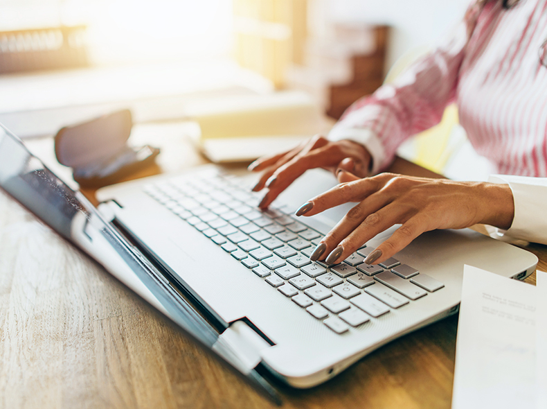 Woman typing on a laptop