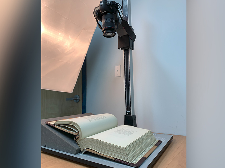 Camera above a book which is laying open on a table