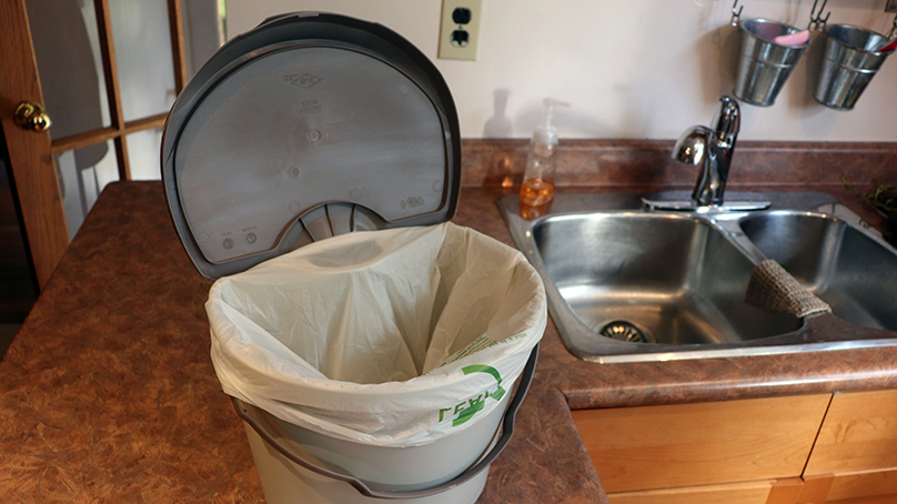 Participants in the pilot project collect their food waste and soiled paper products in their kitchen pail.