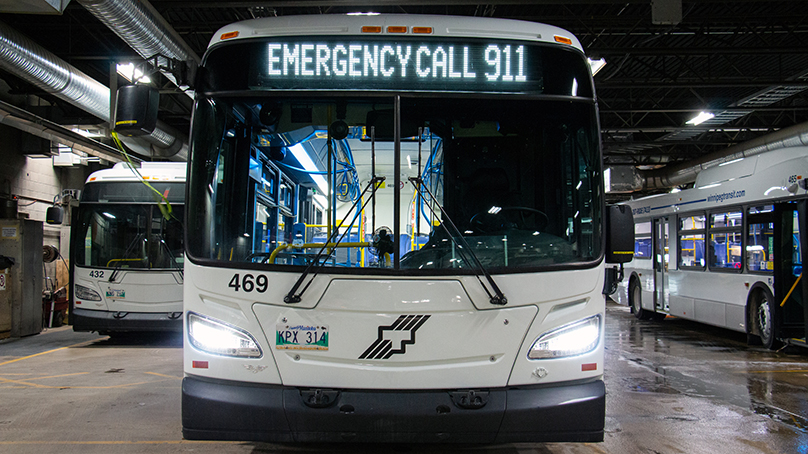 'Emergency Call 911' and 'Do Not Board Bus' is displayed on the front of the bus.