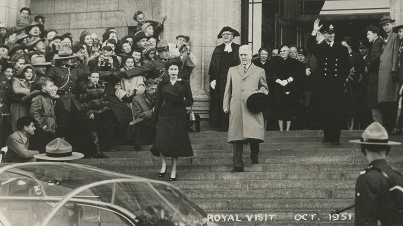 Princess Elizabeth, Duchess of Edinburgh (later Queen Elizabeth II, left) and the Duke of Edinburgh (or Prince Philip) descend the stairs of the Manitoba Legislature.