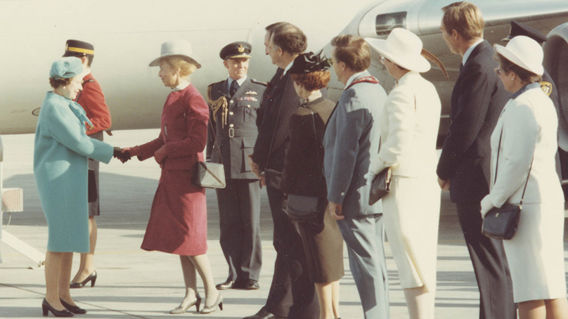 Queen Elizabeth II shaking hands with Pearl McGonigal, Lieutenant Governor of Manitoba, as Winnipeg Mayor Bill Norrie, Premier Howard Pawley, and others wait in receiving line.
