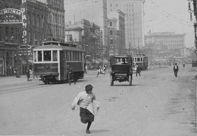 A paper boy running across Portage Avenue moments after World War I was declared, 1914. Archives of Manitoba, T. Burns Collection No. 684
