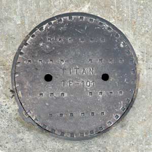 Solid manhole cover in concrete photo